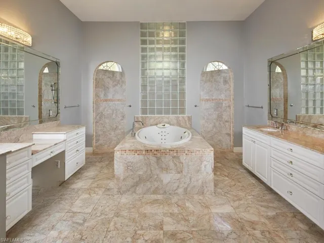 Primary bath with soaking tub, dual vanities, and walk-in shower.