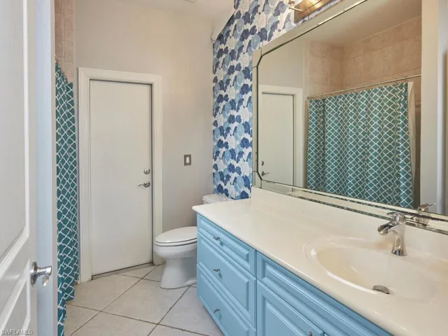 Charming full bath with bold tile accents and a modern vanity.