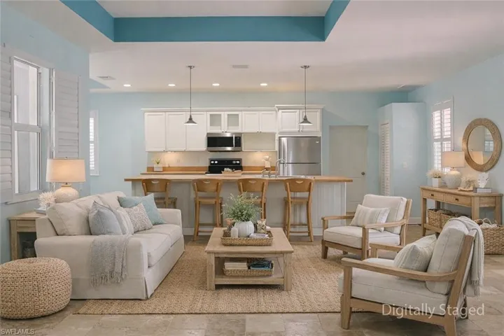 Living room with recessed lighting and light stone finish floors