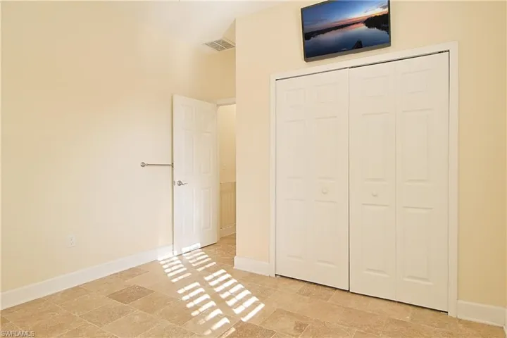 Unfurnished bedroom featuring baseboards and a closet