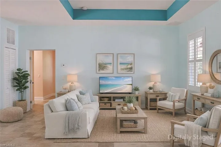 Living room with a raised ceiling and baseboards