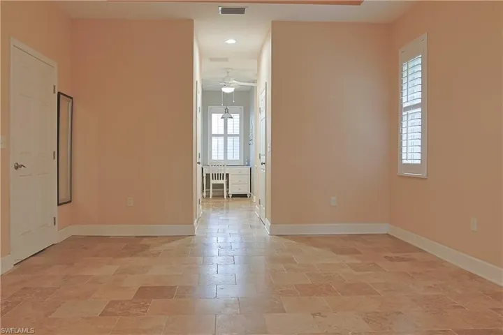 Spare room with stone tile flooring, ceiling fan, and recessed lighting