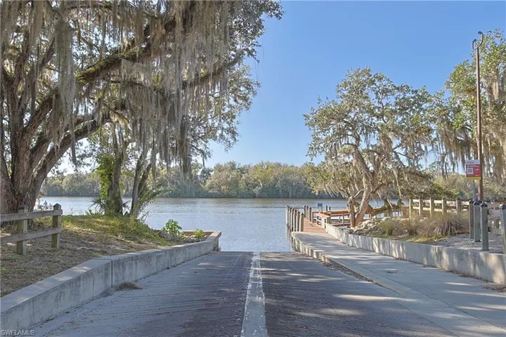 Dock area with a boat ramp and a water view
