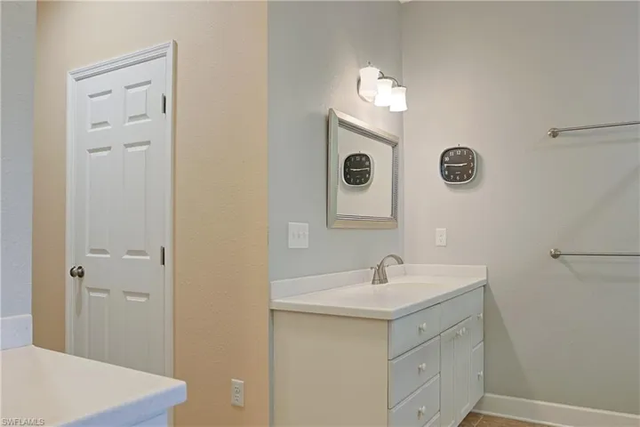 Bathroom with vanity and a textured wall