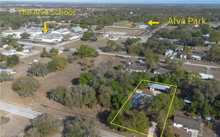 Aerial view of property and surrounding area with property parcel outlined