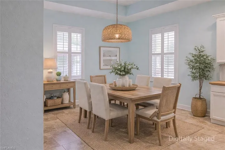 Dining space featuring plenty of natural light and a raised ceiling