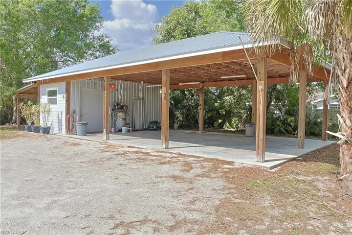 View of parking featuring a carport