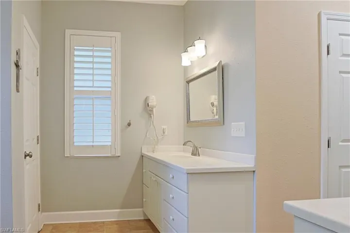 Bathroom featuring vanity and baseboards