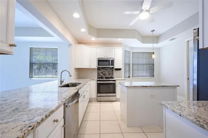 Kitchen with Tray Ceiling and  nice size Breakfast Bar