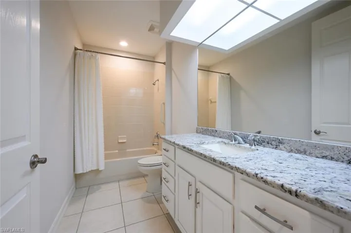 Guest Bathroom with Custom Mirror , Vanity with Granite Counter Top and  shower / bath combo