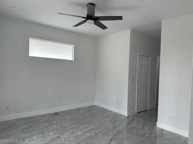Spare room with ceiling fan
