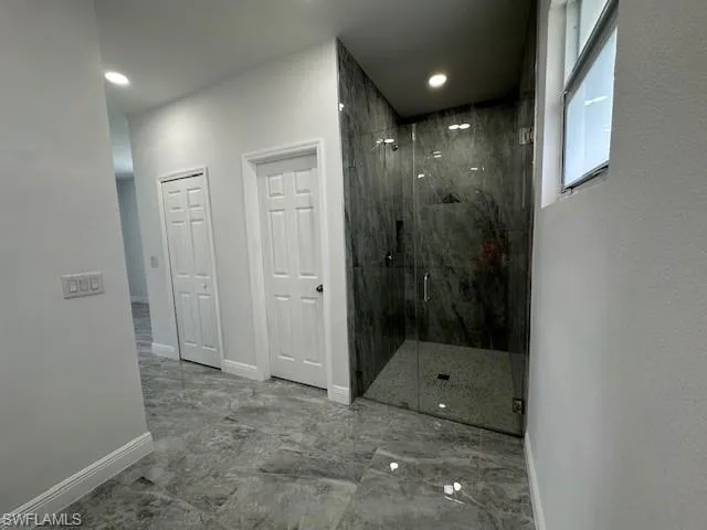 Bathroom with a shower with shower door