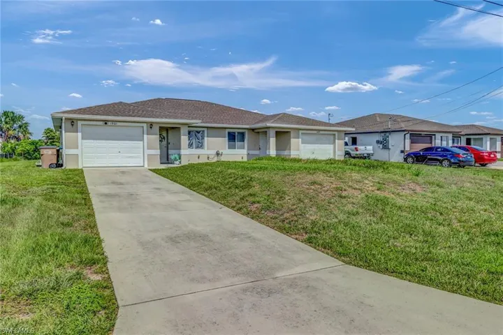 Ranch-style house with a front yard and a garage