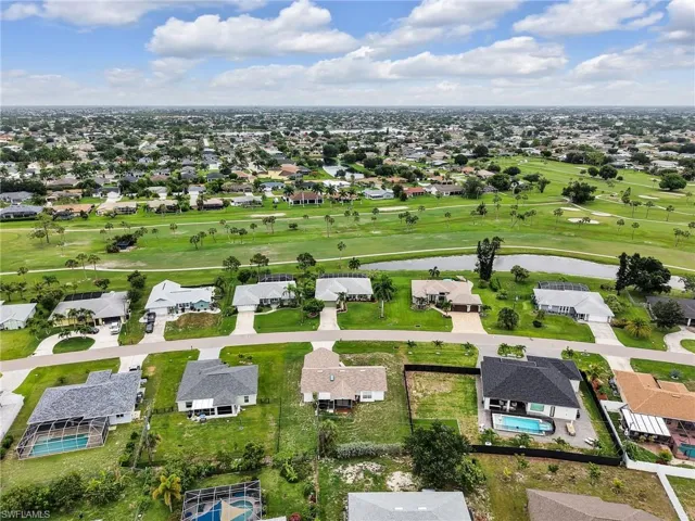 Expansive aerial perspective showcasing a residential community with numerous properties