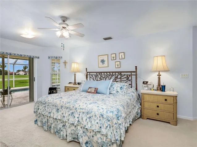 Bedroom featuring light carpeting and pale blue walls