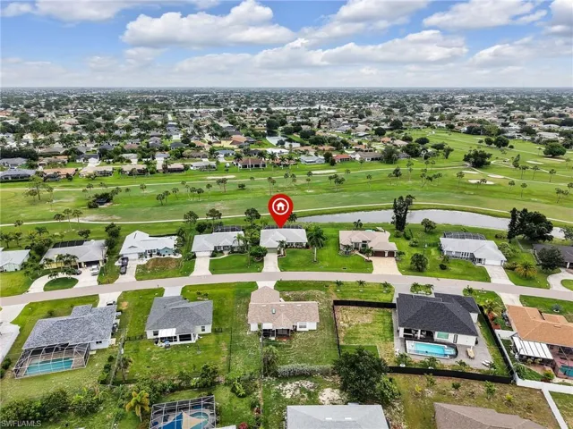 Aerial perspective showcasing a residential area bordered by a golf course