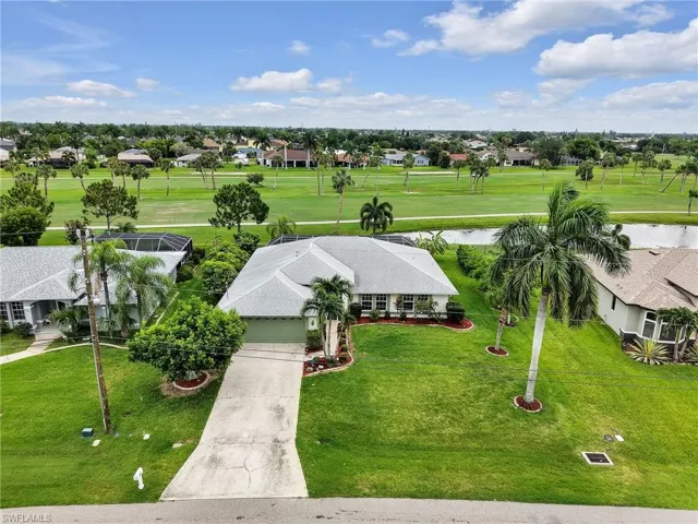 Ranch-style residence featuring a gray shingle roof, green garage door, and a concrete driveway