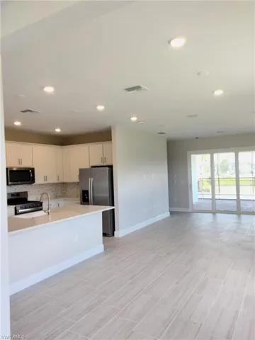 Photo is from a similar Flagstone model. Options for this home may vary. Kitchen, cafe, & gathering room