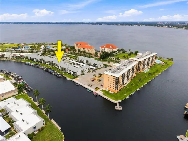 Waterfront community featuring multiple multi-story buildings, boat docks, and direct access to a large body of water