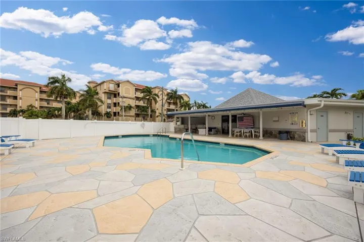 Outdoor swimming pool with a unique geometric shape and surrounding flagstone-style paving