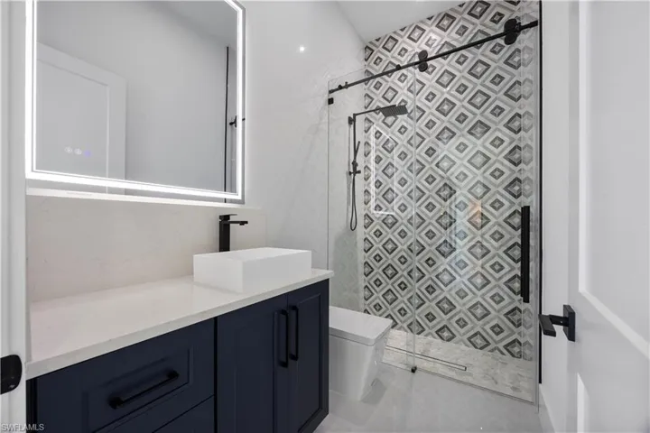 Bathroom with vanity and a shower stall