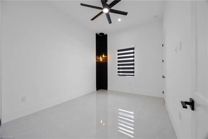 Empty room with a ceiling fan and recessed lighting
