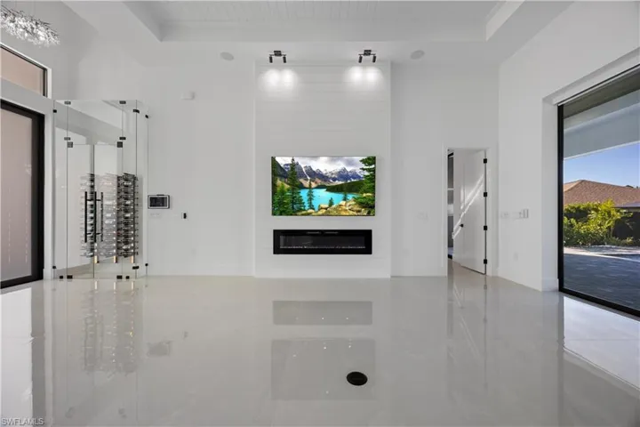 Unfurnished living room featuring a fireplace and wooden ceiling