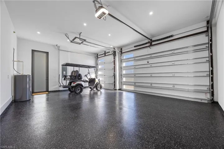 Garage featuring recessed lighting and a garage door opener