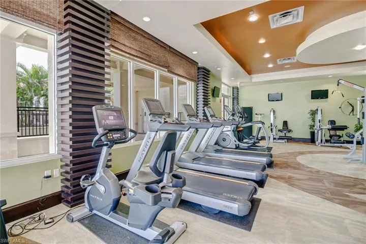 Gym with a raised ceiling and recessed lighting