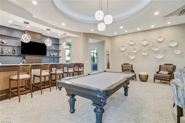 Playroom with billiards, recessed lighting, wet bar, and a raised ceiling