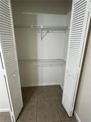 Guest closet features organizing shelves