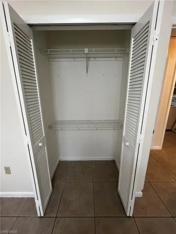 Master bedroom with closet organizer shelving