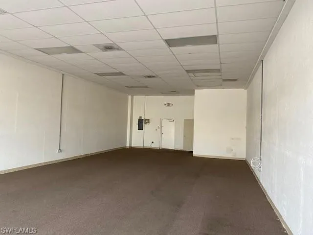 Carpeted spare room with a drop ceiling
