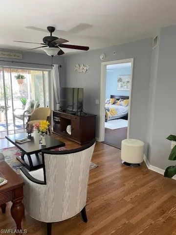 Dining area with a ceiling fan and wood finished floors