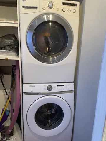 Laundry area featuring stacked washer / drying machine