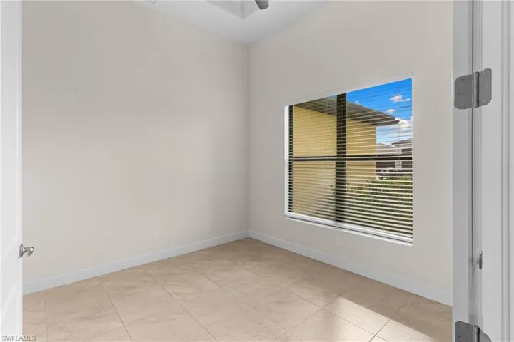 Den includes coffer ceiling and large window