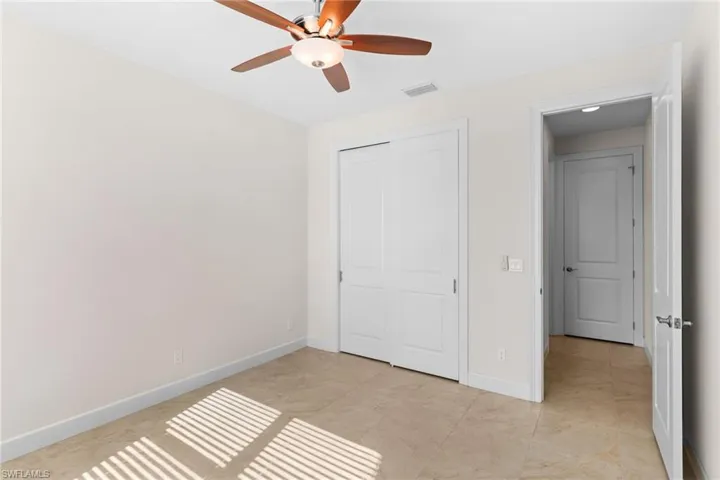 Guest Bedroom with a closet and a ceiling fan