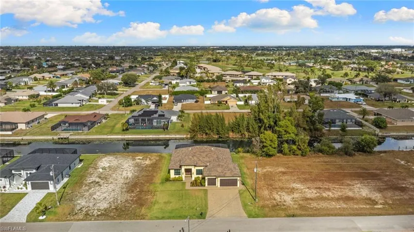 Aerial view of property's location with nearby suburban area
