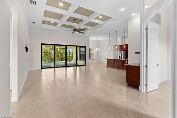 Impressive 12-ft ceilings, coffered ceiling, a chandelier, ceiling fan