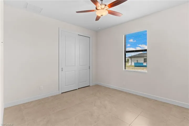Guest Bedroom with ceiling fan and a closet