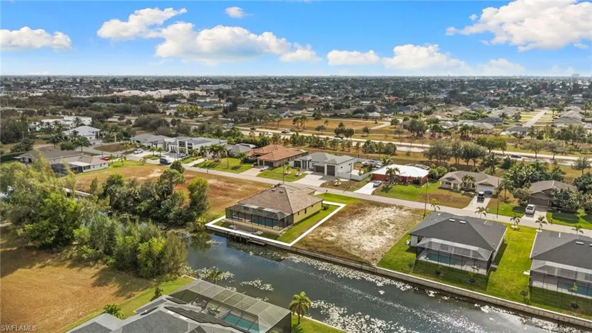 Aerial view of residential area featuring a canal view