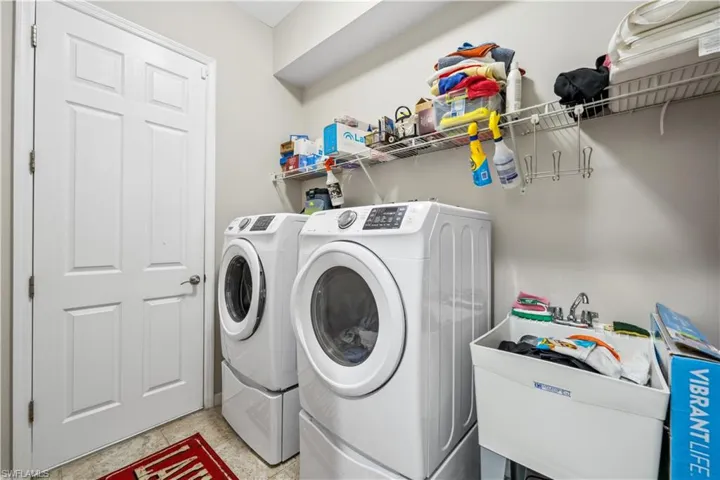 Laundry area with sink and independent washer and dryer
