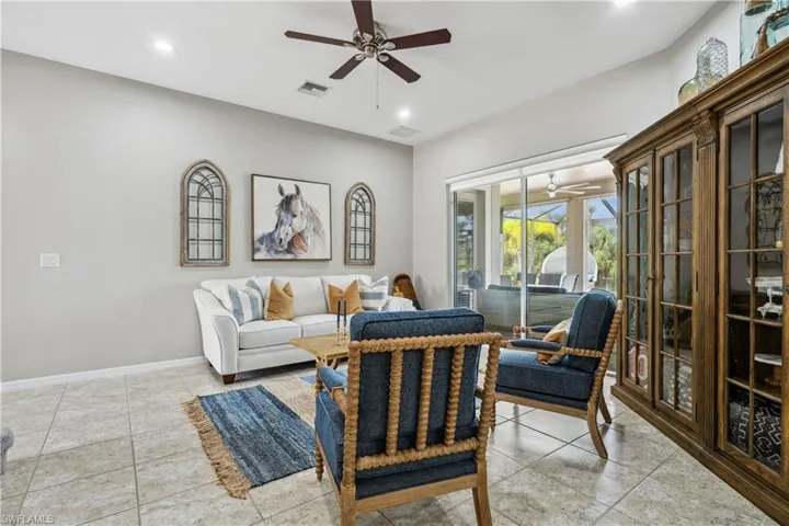 Tiled living room featuring ceiling fan