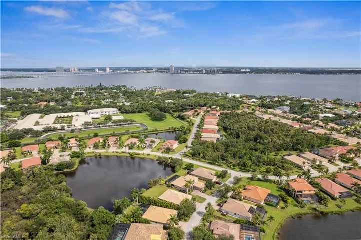 Birds eye view of property with a water view