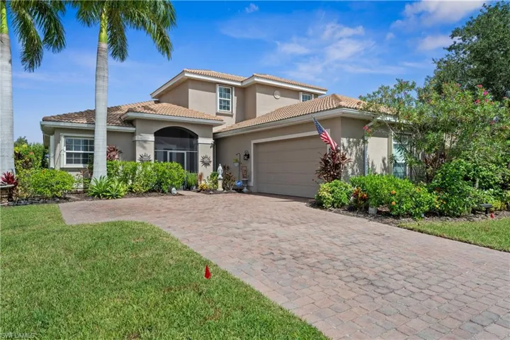 Mediterranean / spanish home with a front lawn and a garage