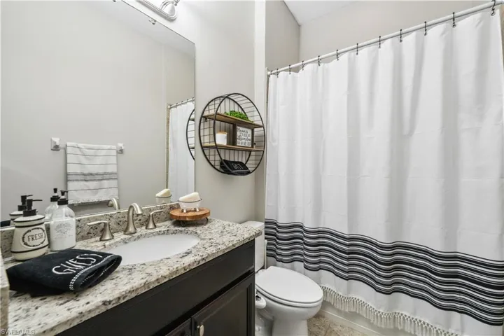 Bathroom with vanity, toilet, and walk in shower