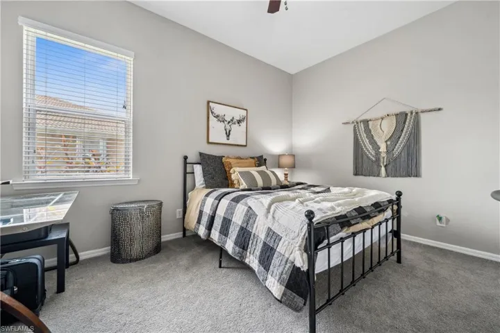 Carpeted bedroom with ceiling fan
