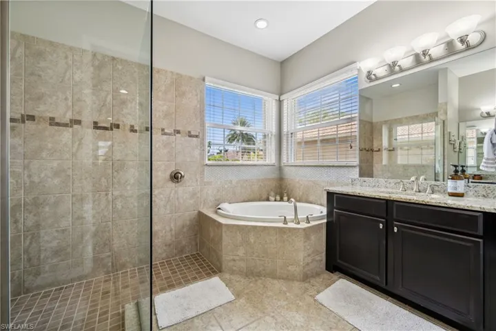 Bathroom with vanity, independent shower and bath, and tile patterned flooring