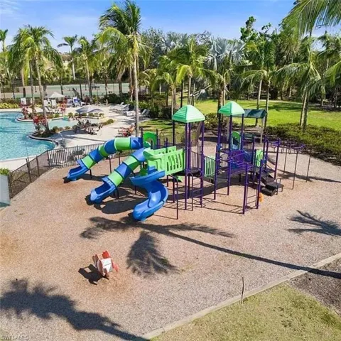 View of playground featuring a community pool