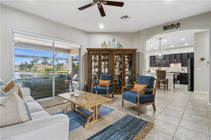 Tiled living room featuring ceiling fan